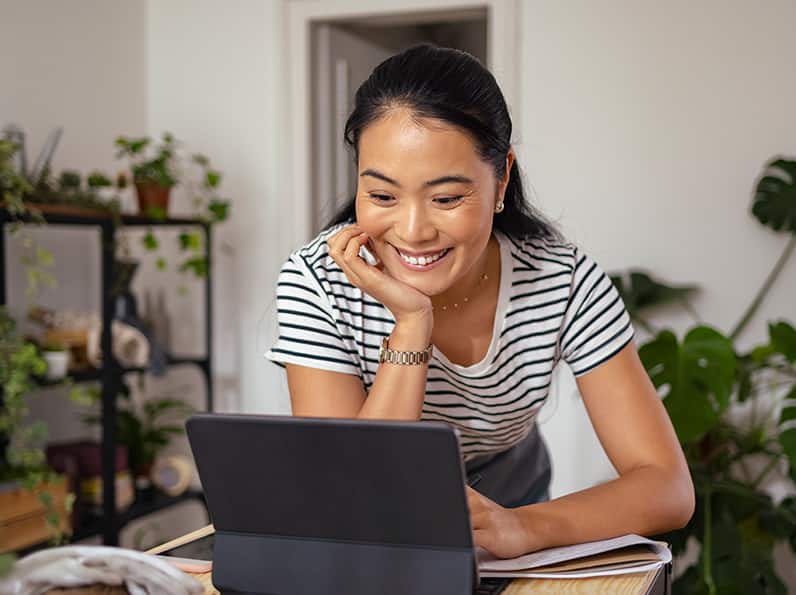 women watching a tab while smiling