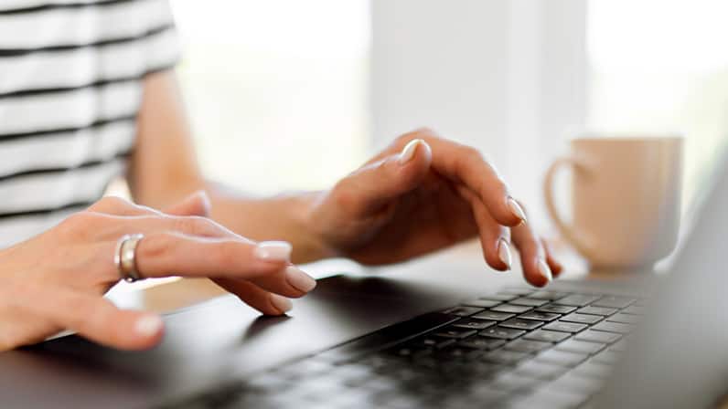 Lady typing on her laptop