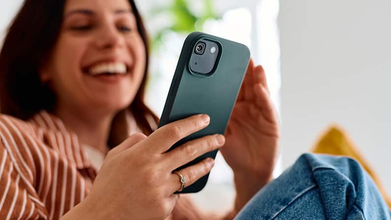 Lady sitting looking at her cell phone