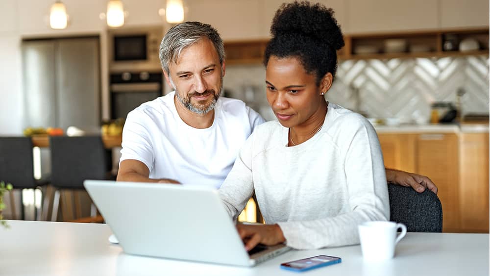 Both girl and boy looking at laptop