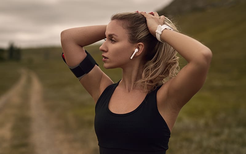 Women running while listening to music on wireless earbuds