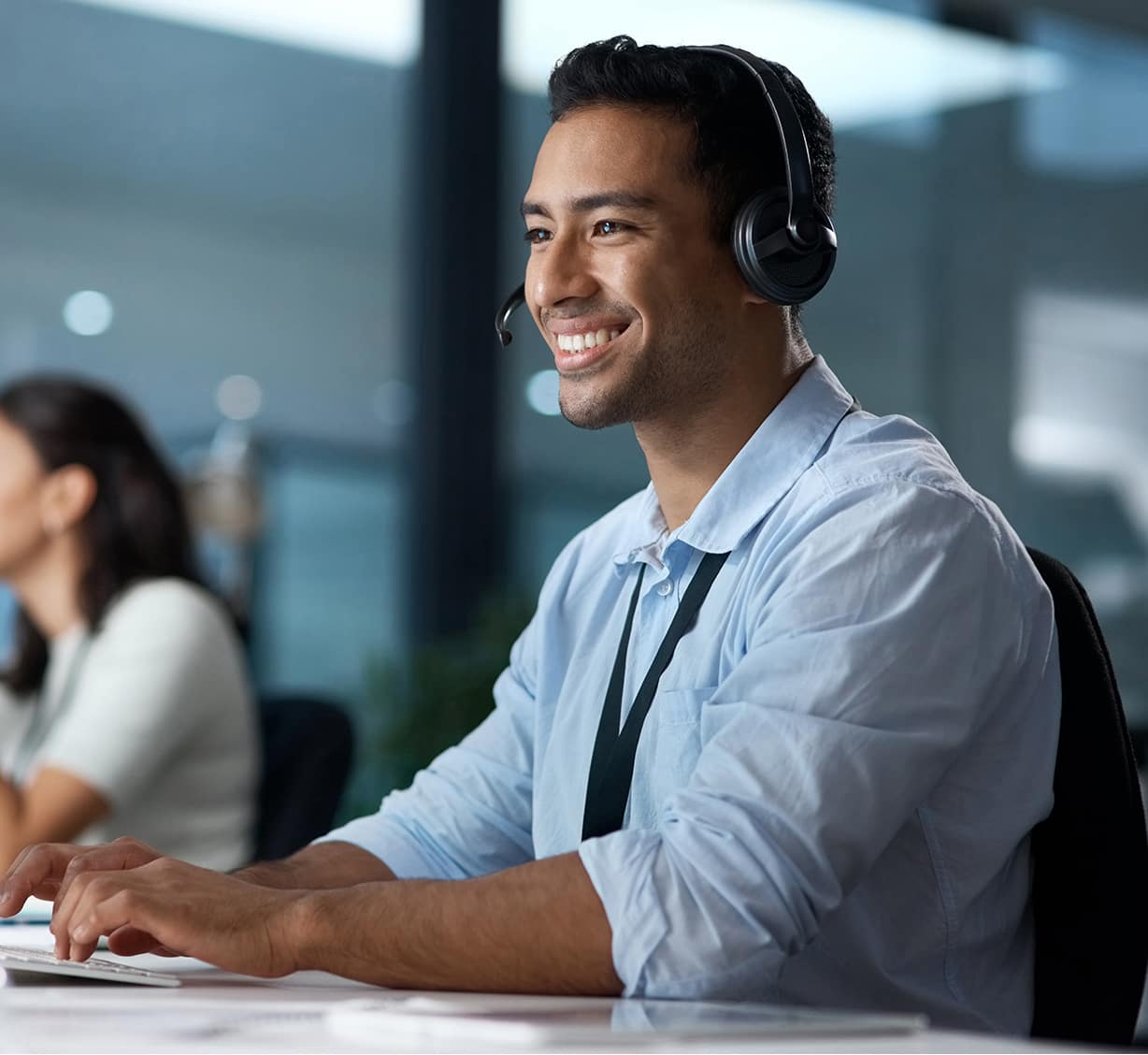 Man having a headset and is looking at computer