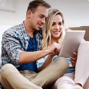 man and woman looking at a tablet