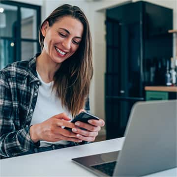 Woman looking at mobile while working