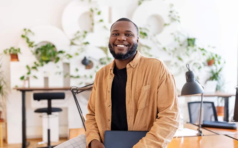 Guy sitting at desk smiling