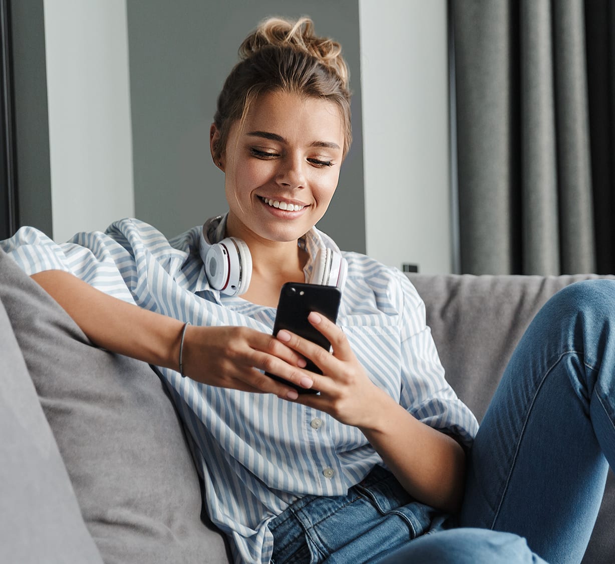 Una mujer con su teléfono móvil en la mano